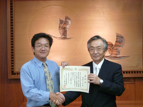 科研費審査委員表彰を受けた田村了以教授（左）と遠藤俊郎学長（右）